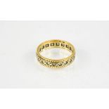 A gold and diamond eternity ring.