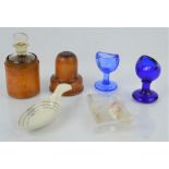 A wooden medicine bottle holder together with vintage eye glass, measuring spoon etc