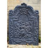 An 18th century cast iron fire back, decorated with two cherubs.