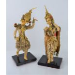 A pair of Indonesian figures on stands