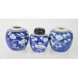 Three blue and white Chinese ginger jars, one with pierced and carved wooden cover, 13cm high.