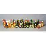A group of mixed miniatures to include Bells whisky , Napoleon brandy and many others