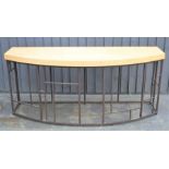 A large metal and wood side table in the style of David Linley