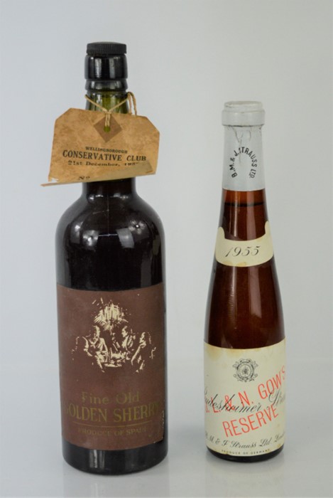 A bottle of vintage B.M & J Strauss 1955 wine together with a bottle of old golden sherry that has a