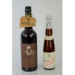 A bottle of vintage B.M & J Strauss 1955 wine together with a bottle of old golden sherry that has a