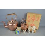 Two Victorian copper kettles together with a group of boxed silver-plate