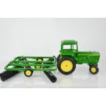 A large John Deere diecast tractor and disc plough