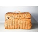 A wicker hamper with picnic accessories.