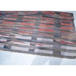 A large hand woven rug, of modern design. 308cm x 252cm