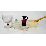 An antique glass cup with five stirring sticks, amethyst coloured jug, pestle & mortar and vintage