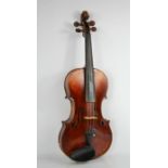 A violin labelled Joseph Guarnerius fecit Cremonae anno 1749 IHS, the two-piece back of medium curl,