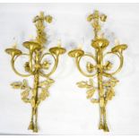 A pair of French Country House brass wall lights, with bow top, two scrolling branches, acorn and