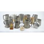 A group of pewter mugs some military related together with a pewter flask.