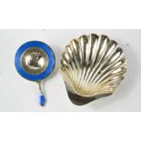 A silver scallop form dish, together with an enamel and white metal tea strainer, marked 925,