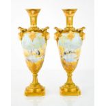 A pair of Royal Worcester vases, painted with cranes in a landscape with face mask handles, signed
