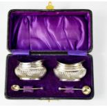 A pair of silver salts, London 1901 by George White, in the original purple velvet and silk lined