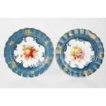 A pair of Royal Worcester plates, painted with fruits and flowers, signed E. Philips, 22cm diameter.