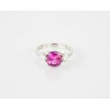 A platinum, pink sapphire and diamond three stone ring, the sapphire approx 2.58ct, size N½, 6.2g.