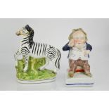 Two 19th century Staffordshire figures; man in a waistcoat, and a zebra, circa 1860.