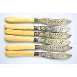 A set of six silver fish knives with bone handles, the knives engraved with fish.
