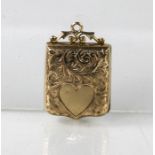 A 9ct antique locket with engraved detail and vacant cartouche, 4.2g