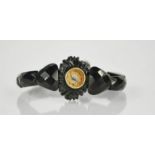 A Victorian jet compass bracelet, the compass set in a carved jet bead, with faceted beads to the