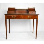An Edwardian ladies mahogany writing desk, with brass gallery rails, leather top, and two frieze