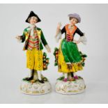 A pair of German porcelain figurines, 16cm high.