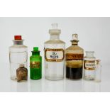 A group of apothecary bottles, some with labels.