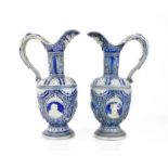 A pair of 20th century German salt glazed ewers, with raised decoration, 34cm high.