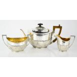 A Victorian silver three piece tea set, of oval form with gadrooned lower body, comprising teapot,