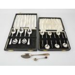 A boxed set of six silver coffee spoons together with a set of silver teaspoons.