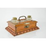 A Victorian oak desk stand with original ink bottles, side drawer and carrying handle.