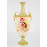 A Royal Worcester twin handled vase, painted with flowers, and mask handles, 33cm high.