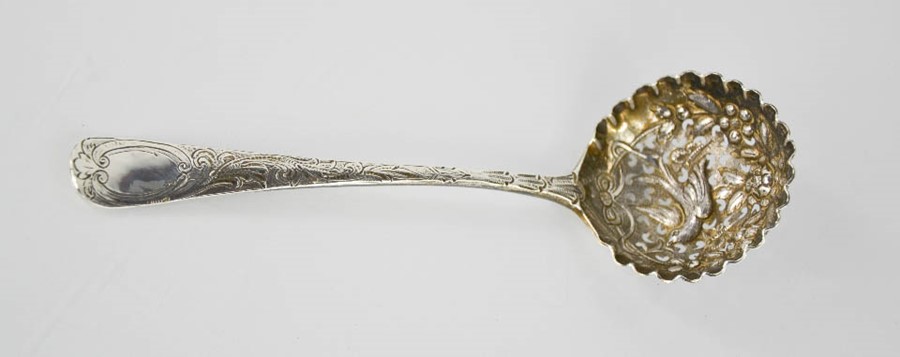 A silver sifter spoon, London 1735, the bowl embossed with flowers, and birds.