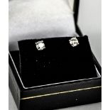 A pair of platinum and diamond stud earrings, the diamonds approx 1ct total in claw setting.