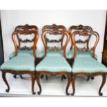 A set of Rosewood chairs, the top rails carved with scrollwork, raised on cabriole legs, in blue