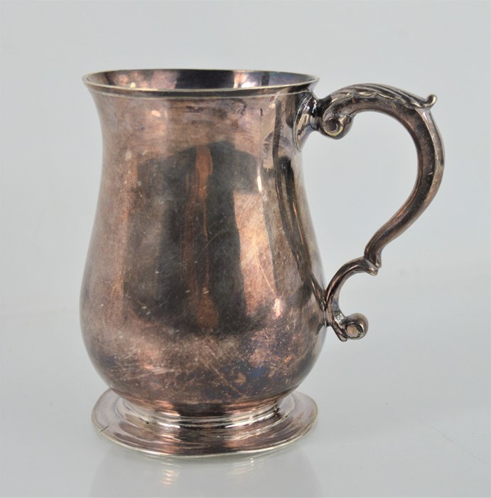 A Georgian Solid silver mug of baluster form by Thomas Moore II - London - 7.33toz