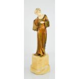 A 19th century bronze and ivory figure of a woman dressed in robes, standing on a marble base, in