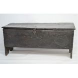 A 17th century five plank oak coffer decorated with a dragon fish to the front, - 45cm h x 104cm x