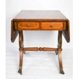 A 19th century mahogany sofa table with brass inlay and lyre form supports.