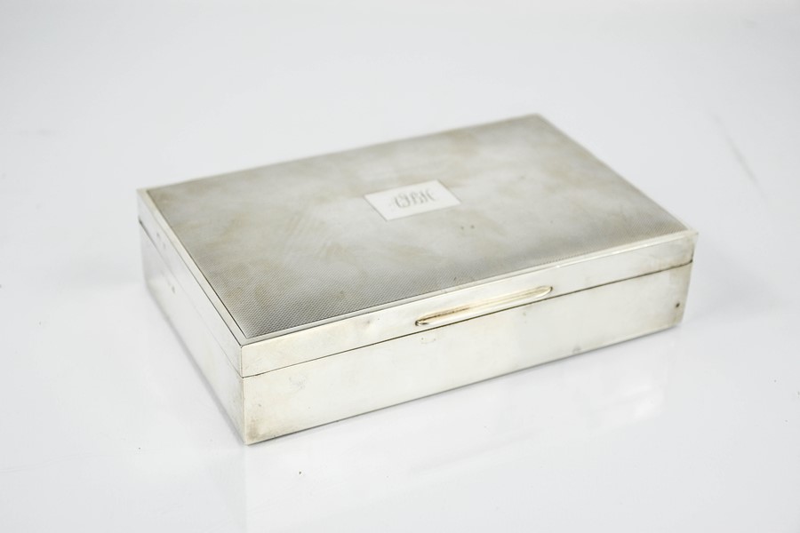 A silver hallmarked cigarette box, monogrammed to the lid AJBH.