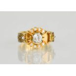 An 18ct gold buckle ring, centred by a diamond approximately 0.35cts and set with twelve further