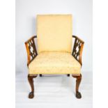 A walnut 19th century Chippendale design arm chair with pierced arms, cream upholstered seat,