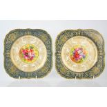 A pair of Royal Worcester plates with flowers to the centres, circa 1920, signed Barker, 22cm wide.