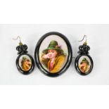 A 19th century Whitby jet and porcelain brooch and earring set, each hand painted with portraits