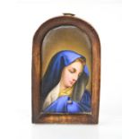 A 19th century porcelain plaque, portrait of Saint Mary, in an arch form frame.