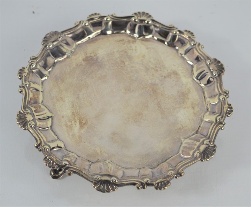 A George III Sterling silver waiter with gadrooned borders raised on three feet by Elizabeth