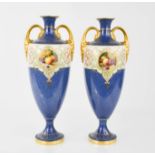 A pair of Royal Worcester vases, by Horace Price, urn form with twin handles, with blue ground,