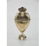 A continental white metal heart form trinket box, surmounted with a crown and raised on four ball